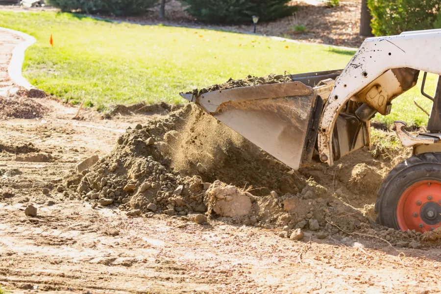 Bulldozer carrying loose soil in a plot in Howell, MI